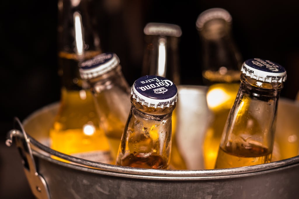 Close-up of chilled beer bottles in an ice bucket, perfect for bars and parties.