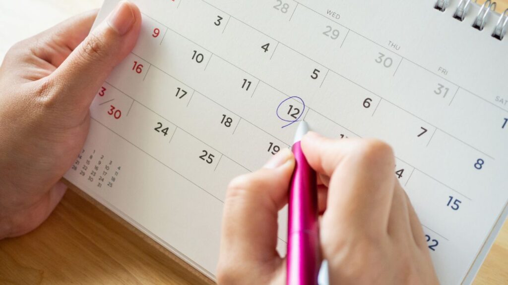 pessoa realizando anotação em calendario